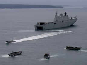 The Royal Australian Navy HMAS Adelaide dislodges landing crafts with Philippine Marines and Australian troops as they conduct a joint Humanitarian Aid and Disaster Relief (HADR) exercise off Subic Bay in northwestern Philippines Sunday, Oct. 15, 2017. The HMAS Adelaide, along with another Australian Navy ship, the HMAS Darwin, a guided missile frigate, are here for a goodwill visit aimed at strengthening relations between the two navies as well as maritime security and stability in the region. (AP Photo/Bullit Marquez)