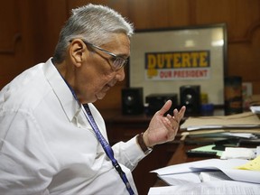 In this photo taken Monday, Oct. 9, 2017, the Department of Justice Chief State Counsel Ricardo Paras shows an extradition request by the U.S. government for Filipino doctor Russell Salic accused by U.S. authorities of plotting  terrorist attacks in New York city during an Associated Press interview in Manila, Philippines. On Tuesday, Oct. 10, 2017, the lawyer for Salic, the orthopedic doctor who is now detained in Manila, said he donated money to charity but not to terrorists and is a 37-year-old Muslim who renounces terrorism and has never held a gun in his life. (AP Photo/Bullit Marquez)