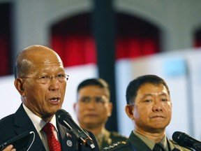 Philippine Defense Secretary Delfin Lorenzana, left, together with Armed Forces Chief Gen. Eduardo Ano, right, reads a statement announcing the Philippine troops have captured a building where pro-Islamic State group militants made their final stand in southern Marawi city and found bodies of suspected gunmen inside Monday, Oct. 23, 2017 at the ongoing ASEAN Defense Ministers' Meeting in Clark, Pampanga province north of Manila, Philippines. The seizure of the building and the defeat of the militants would allowed the military to declare on Monday the end of the Marawi siege, which hundreds of black flag-waving gunmen launched exactly five months ago. (AP Photo/Bullit Marquez)