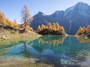 Lake  Lac Bleu is pictured during a beautiful autumn day, near Arolla, in Valais, Switzerland, this Wednesday, Oct. 18, 2017. (Anthony Anex/Keystone via AP)
