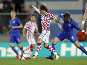 Croatia's Luka Modric, left, is challenged by Finland's Perparim Hetemaj during the World Cup Group I qualifying soccer match between Croatia and Finland, at the Rujevica stadium in Rijeka, Croatia, Friday, Oct. 6, 2017. (AP Photo/Darko Bandic)