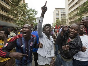 Supporters of Kenya's President Uhuru Kenyatta chant slogans near the Supreme Court, after it failed to reach quorum to hear a petition calling for a halt in the presidential election, in downtown Nairobi, Kenya Wednesday, Oct. 25, 2017. The chief justice of Kenya's Supreme Court says the court cannot hear a last-minute petition to postpone Thursday's presidential election because it does not have a quorum of judges. (AP Photo/Darko Bandic)