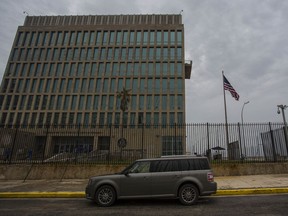A car is parked outside the compound of the United States embassy in Havana, Cuba, Friday, Sept. 29, 2017. The United States issued an ominous warning to Americans on Friday to stay away from Cuba and ordered home more than half the U.S. diplomatic corps, acknowledging neither the Cubans nor America's FBI can figure out who or what is responsible for months of mysterious health ailments. (AP Photo/Desmond Boylan)