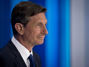 President incumbent Borut Pahor looks at his counter-candidates ahead of a televised debate at Slovenia's public TV, in Ljubljana, Slovenia, Thursday, Oct. 19, 2017. Slovenia, the Alpine home country of Melania Trump, is holding a presidential election Sunday that incumbent President Borut Pahor _ a former fashion model, like the U.S. first lady _ is favored to win. Eight other candidates are vying for the largely ceremonial, but still influential head of state post.(AP Photo/Darko Bandic)
