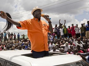 Opposition leader Raila Odinga greets his supporters after attending a church service in the slum of Kawangware in Nairobi, Kenya, Sunday, Oct. 29, 2017. Warning that Kenya is in "grave danger", opposition leader Raila Odinga said in an interview with The Associated Press on Sunday that the country's repeat presidential election was a sham and that a new vote should be held within 90 days. (AP Photo/Darko Bandic)