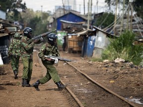 Police aim their weapons as they patrol during clashes in Kibera slum in Nairobi, Kenya, Thursday, Oct. 26, 2017. Kenyan police on Thursday fired tear gas at stone-throwing protesters in some opposition areas after the start of Kenya's second presidential election since August, reflecting bitter divisions in a country whose main opposition leader urged his followers to boycott the vote. (AP Photo/Darko Bandic)