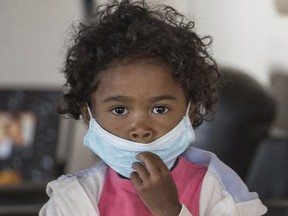 A child wears a face mask at a school in Antananarivo, Madagascar, Tuesday, Oct. 3, 2017. Authorities in Madagascar are struggling to contain an outbreak of plague that has killed at least two dozen people, and the government has begun a campaign to disinfect school classrooms in the city. (AP Photo/Alexander Joe)
