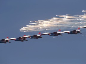 MiG-29 jet fighters of Russian aerobatic team Strizhi (Swifts) perform during a ceremony in Batajnica, military airport near Belgrade, Friday, Oct. 20, 2017. Russia has formally handed over six MiG-29 fighter jets to Serbia, part of an arms delivery that could worsen tensions in the war-weary Balkans. (AP Photo/Darko Vojinovic)