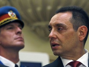 In this photo taken Thursday, June 29, 2017, Serbian Defense Minister Aleksandar Vulin, right, attends the Government swearing in ceremony at the Serbian Parliament building, in Belgrade, Serbia. Vulin has praised a convicted war criminal for his role in the defense against NATO's 1999 intervention in Kosovo, saying the Balkan country no longer has to be ashamed of a bloody crackdown against ethnic Albanian separatists. (AP Photo/Darko Vojinovic)