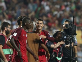 Portugal's Cristiano Ronaldo, center, celebrates with his teammates at the end of the World Cup Group B qualifying soccer match between Portugal and Switzerland at the Luz stadium in Lisbon, Tuesday, Oct. 10, 2017. (AP Photo/Armando Franca)