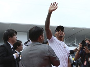 Mercedes driver Lewis Hamilton of Britain greets fans during a fan meeting ahead of the Japanese Formula One Grand Prix at the Suzuka Circuit in Suzuka, central Japan Thursday, Oct. 5, 2017. (AP Photo/Eugene Hoshiko)