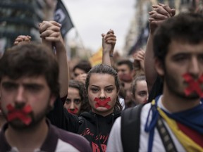 Independence supporters march during a demonstration downtown Barcelona, Spain, Monday, Oct. 2, 2017. Catalan leaders accused Spanish police of brutality and repression while the Spanish government praised the security forces for behaving firmly and proportionately. Videos and photographs of the police actions were on the front page of news media outlets around the world. (AP Photo/Felipe Dana)