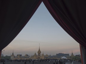 Thai mourners gather in front of the royal crematorium of late Thai King Bhumibol Adulyadej in Bangkok, Thailand early Friday, Oct. 27, 2017. Thai King Maha Vajiralongkorn participated in religious rituals on Friday to move his father, late King Bhumibol Adulyadej's ashes to special locations for further Buddhist rites. (AP Photo/Kittinun Rodsupan)