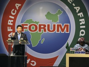 FILE - In this Dec. 4, 2015 file photo, Chinese President Xi Jinping, left, delivers his speech during the opening ceremony of the Johannesburg Summit for the Forum on China-Africa Cooperation at the Sandton Convention Centre in Johannesburg. A new report says on Wednesday, Oct. 11, 2017,  China is closing to matching the United States as a top global source of official grants and loans to developing countries. But it says much of Beijing's financing serves its own economic interests and produces little growth for recipients. (AP Photo, File)