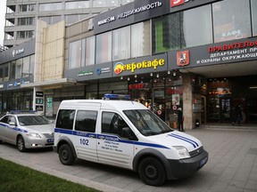 Police vehicles parked outside a building where the Ekho Moskvy (Echo of Moscow) radio station office is located in Moscow, Russia, Monday, Oct. 23, 2017. Russia's leading news radio station said on Monday its deputy editor-in-chief has been stabbed by an unknown attacker. (AP Photo/Alexander Zemlianichenko)