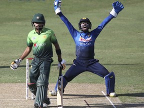 Sri Lanka's wicket keeper appeals as Pakistan's Babar Azam looks on during their first ODI cricket match against Pakistan in Dubai, United Arab Emirates, Friday, Oct. 13, 2017. (AP Photo/Kamran Jebreili)