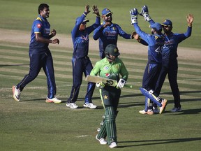 Sri Lanka's bowler Thisara Perera, 1st left, celebrates with his team-mates dismissal of Pakistan's Shoaib Malik during their second ODI cricket match in Abu Dhabi, United Arab Emirates, Monday, Oct. 16, 2017. (AP Photo/Kamran Jebreili)