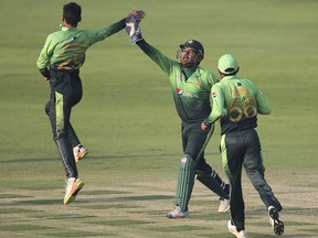 Pakistan's bowler Shadab Khan celebrates with Sarfaraz Ahmed dismissal of Sri Lanka's Dinesh Chandimal during their third ODI cricket match in Abu Dhabi, United Arab Emirates, Wednesday, Oct. 18, 2017. (AP Photo/Kamran Jebreili)