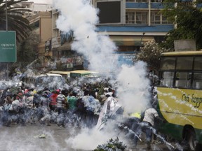 Riot police fire teargas against opposition supporters during a demonstration against the Independent Electoral and Boundaries Commission (IEBC) in Nairobi, Kenya, Wednesday, Oct. 11, 2017. The protesters are demanding a change of leadership at the country's election commission. The protests took place in the capital Nairobi and the opposition stronghold of Kisumu, in western Kenya, as well as in the coastal city of Mombasa.(AP Photo/Khalil Senosi)