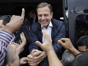 FILE - In this Sept. 30, 2016 file photo, Joao Doria, mayoral candidate with the Brazilian Social Democracy Party, greets supporters during a campaign rally in Sao Paulo, Brazil. Mayor Doria said on Wednesday, Oct. 18, 2017, that the city will feed school kids with pellets made of a mix of unwanted and nearly expired items. (AP Photo/Andre Penner)