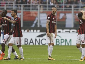 AC Milan's Leonardo Bonucci, center, looks back after receiving a red card from the referee during a Serie A soccer match between AC Milan and Genoa, at the San Siro stadium in Milan, Italy, Sunday, Oct. 22, 2017. (AP Photo/Luca Bruno)