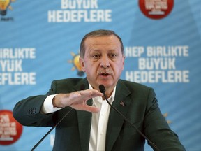Turkey's President Recep Tayyip Erdogan, gestures as he delivers a speech at his ruling political party's conference in Afyonkarahisar province in western Turkey, Saturday, Oct. 7, 2017. Erdogan has announced the country is conducting a "serious" operation against extremist groups in Syria's northwestern Idlib province with Turkey-backed rebels. (Yasin Bulbul/Pool Photo via AP)