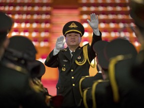 A conductor leads a band in rehearsals before the opening session of China's 19th Party Congress at the Great Hall of the People in Beijing, Wednesday, Oct. 18, 2017. (AP Photo/Mark Schiefelbein)