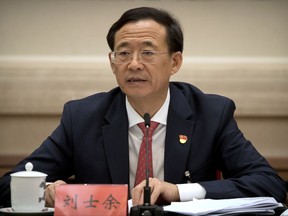 In this Thursday, Oct. 19, 2017, photo, Liu Shiyu, chairman of the China Securities Regulatory Commission, speaks during a discussion group meeting held on the sidelines of China's 19th Party Congress at the Great Hall of the People in Beijing. Liu on Thursday accused the former party secretary of Chongqing, Sun Zhengcai, of plotting a coup against the party leadership in the clearest explanation yet of the abrupt firing of the former rising star. (AP Photo/Mark Schiefelbein)