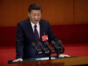 Chinese President Xi Jinping delivers a speech during the opening session of China's 19th Party Congress at the Great Hall of the People in Beijing, Wednesday, Oct. 18, 2017. Xi on Wednesday urged a reinvigorated Communist Party to take on a more forceful role in society and economic development to better address "grim" challenges facing the country as he opened a twice-a-decade national congress. (AP Photo/Mark Schiefelbein)