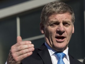 In this Aug. 24, 2017 photo New Zealand Prime Minister Bill English gestures during a speech in Christchurch, New Zealand. The main conservative and liberal parties are competing to form a government after an election last month ended with an inconclusive result. Crucial to the negotiations is the small New Zealand First party, led by maverick lawmaker Winston Peters.(AP Photo/Mark Baker)