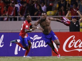 Costa Rica's Kendall Waston, right, celebrates after scoring his team's equalizer against Honduras during a World Cup qualifying soccer match at the National Stadium in San Jose, Costa Rica, Saturday, Oct 7, 2017. (AP Photo/Moises Castillo)