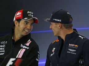 Force India driver Sergio Perez, of Mexico, left, talks with Red Bull driver Max Verstappen of the Netherlands, during a press conference at the Hermanos Rodriguez racetrack in Mexico City, Thursday, Oct. 26, 2017. (AP Photo/Moises Castillo)
