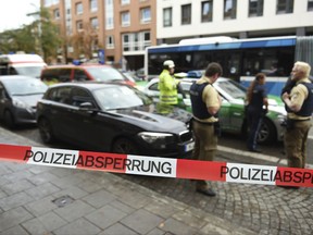 Police guard the area at Rosenheimer Platz square in Munich, Germany, Saturday, Oct. 21, 2017. Police say a man with a knife has lightly wounded several  people in Munich. Officers are looking for the assailant. Munich police called on people in the Rosenheimer Platz  square area, located close to the German city's downtown, to stay inside after the incident on Saturday morning. (Andreas Gebert/dpa via AP)
