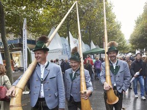 Bavarian alphorn blowers arrive in Mainz, Germany Monday, Oct. 2, 2017 one day ahead of the celebrations for the 27th anniversary of the German reunification. (Thomas Frey/dpa via AP)