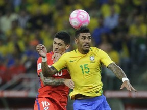 Brazil's Paulinho, right, jumps for a header with Chile's Pablo Hernandez during a World Cup qualifying soccer match in Sao Paulo, Brazil, Tuesday, Oct. 10, 2017. (AP Photo/Nelson Antoine)