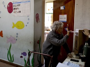 A woman casts her vote during midterm legislative elections in Buenos Aires, Argentina, Sunday, Oct. 22, 2017. Legislative elections in Argentina are giving President Mauricio Macri a chance to win his first friendly congress, while former President Cristina Fernandez is seeking to make a comeback. (AP Photo/Natacha Pisarenko)