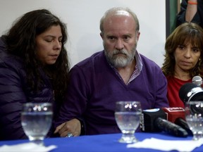Santiago Maldonado's family lawyer Veronica Heredia, right, Santiago Maldonado's brother Sergio Maldonado, and his partner Andrea Antico attend a press conference in Esquel, Argentina, Wednesday, Oct. 18, 2017. Argentine investigators think they have found the body of the protester whose disappearance more than two months ago prompted large demonstrations demanding the government find him alive, officials said Wednesday. (AP Photo/Natacha Pisarenko)