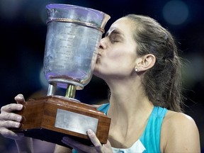 Julia Goerges of Germany kisses the trophy after winning the final match at the Kremlin Cup tennis tournament against  Daria Kasatkina of Russia, in Moscow, Russia, Saturday, Oct. 21, 2017. (AP Photo/Pavel Golovkin)