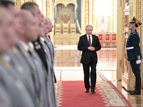 Russian President Vladimir Putin, center, walks in a hall during a meeting with senior military officers in the Kremlin in Moscow, Russia, Thursday, Oct. 26, 2017. (Alexei Nikolsky, Kremlin Pool Photo via AP)