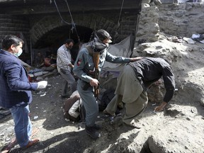 Afghan health workers and security personnel conduct a campaign to collect drug users in Kabul, Afghanistan, Tuesday, Oct. 24, 2017. The process is part of a new campaign in the country with one of the highest rates of drug use in the world.(AP Photo/Rahmat Gul)