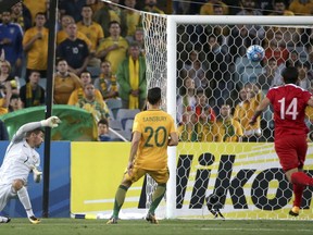 Australia's goal keeper Mathew Ryan, left, turns to see the ball go in for a Syrian goal during their Soccer World Cup qualifying match in Sydney, Australia, Tuesday, Oct. 10, 2017. (AP Photo/Rick Rycroft)