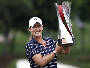Cristie Kerr of the United States poses with his trophy after winning the Sime Darby LPGA golf tournament at Tournament Players Club (TPC) in Kuala Lumpur, Malaysia, Sunday, Oct. 29, 2017. (AP Photo/Sadiq Asyraf)