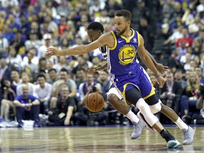 Golden State Warriors' Stephen Curry, foreground, blocks Minnesota Timberwolves' Jeff Teague during their preseason NBA game in Shanghai, China, Sunday, Oct. 8, 2017. (AP Photo)
