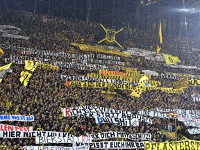 FILE - In this Feb. 4, 2017 file photo, Dortmund's supporters protest against the Red Bull owned RB Leipzig club prior the German Bundesliga soccer match between Borussia Dortmund and RB Leipzig in Dortmund, Germany. Police are braced for trouble on Saturday Oct. 14, 2017 as Leipzig returns to Borussia Dortmund in the Bundesliga for the first time since violent scenes overshadowed their game last season. Dortmund was fined and forced to close its 24,454-capacity south stand for one game following Leipzig's previous visit on Feb. 4, when some of its fans were attacked with stones and bottles, police officers were injured. (AP Photo/Martin Meissner, file)