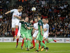 England's Harry Kane, left, heads the ball during the World Cup Group F qualifying soccer match between England and Slovenia at Wembley stadium in London, Thursday, Oct. 5, 2017. (AP Photo/Frank Augstein)