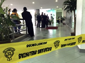 An entrance of the Shah Alam court house is cordoned off as the trial of two women accused of killing North Korean leader's brother is held in Shah Alam, Malaysia, Wednesday, Oct. 4, 2017. Siti Aisyah of Indonesia and Doan Thi Huong of Vietnam pleaded not guilty on Monday, the trial's first day, to killing Kim Jong Nam on Feb. 13 at a crowded Kuala Lumpur airport terminal. They are accused of wiping VX on Kim's face in an assassination widely thought to have been orchestrated by North Korean leader Kim Jong Un. (AP Photo/Vincent Thian)