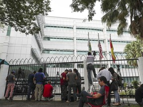 Journalists wait outside a laboratory in Petaling Jaya, Malaysia, Monday, Oct. 9, 2017. The trial of two women accused of killing the estranged half brother of North Korea's leader entered its second week Monday, with the court moving temporarily to the high-security laboratory to view evidence contaminated with VX nerve agent. (AP Photo/Vincent Thian)