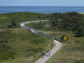 Visitors walk on the boardwalk on the Greenwich peninsula portion of Prince Edward Island National Park in Greenwich, Prince Edward Island on Tuesday, Aug. 29, 2017.