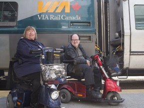 Martin Anderson and Marie Murphy are pictured in front of a Via Rail train at Toronto's Union Station on May 13, 2017. The Canadian Transportation Agency is rejecting Via Rail's efforts to limit access on its trains for passengers using wheelchairs and other mobility aids.