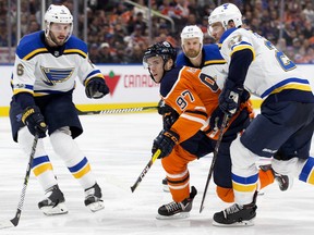 The Oilers' Connor McDavid tries to find room between three St. Louis Blues players at Rogers Place on Thursday Nov. 16, 2017.